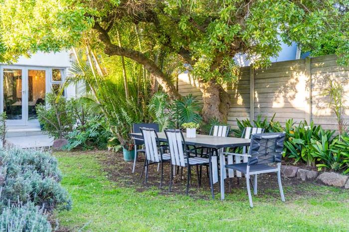 Outdoor dining table under the trees in the garden