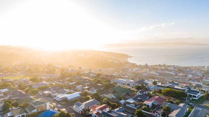 Golden-hour aerial view of Mossel Bay harbour and the bay from above Villa Palmera