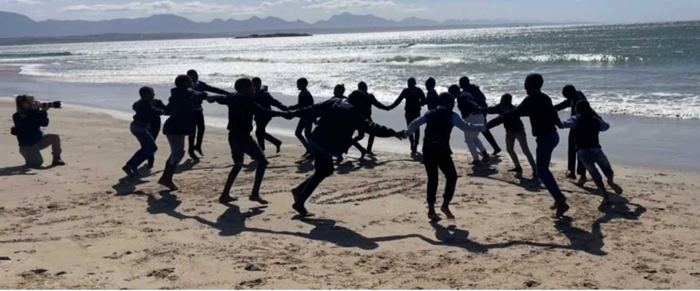 iOcean Trust group jumping for joy on the beach at Mossel Bay