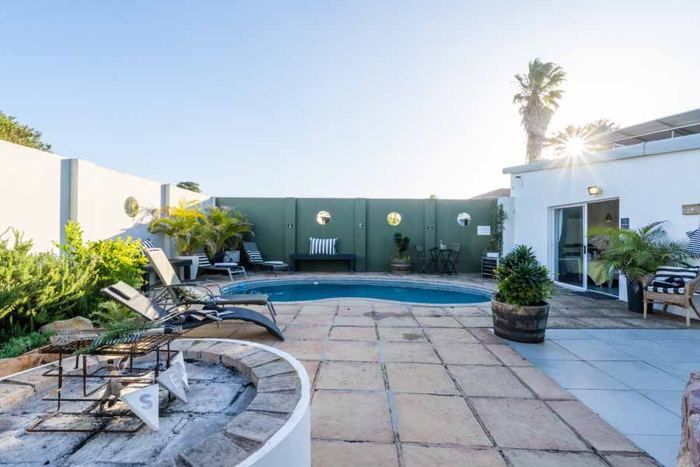 Morning sun on the pool terrace at Villa Palmera